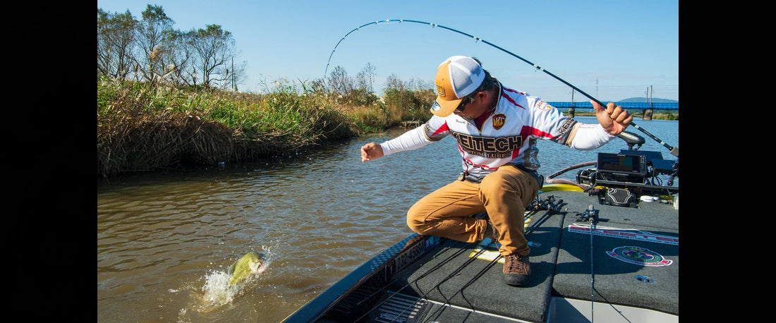 Kei Hayashi, founder of Keitech, fighting a bass during a tournament in Japan while using Keitech lures