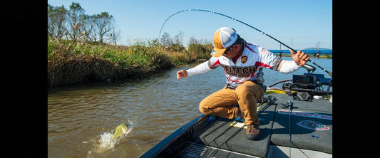 Kei Hayashi, founder of Keitech, fighting a bass during a tournament in Japan while using Keitech lures